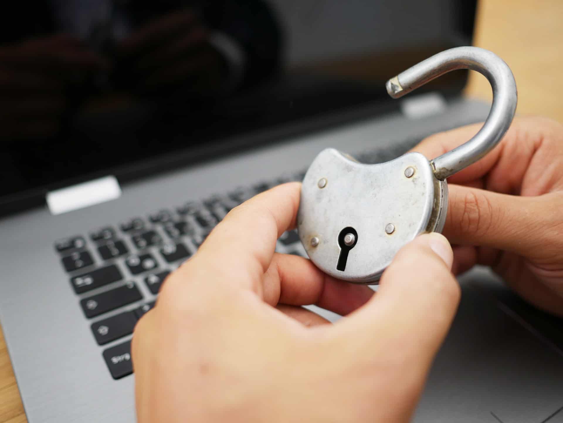 Padlock held over a laptop.